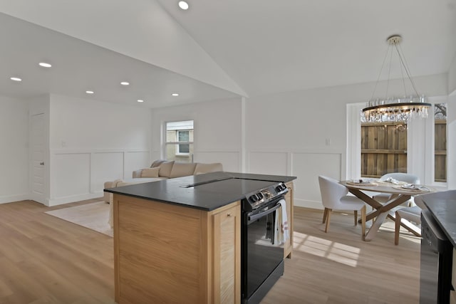 kitchen featuring dark countertops, black range with electric stovetop, vaulted ceiling, light wood-type flooring, and stainless steel dishwasher