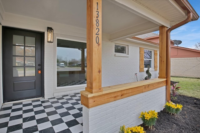 entrance to property with brick siding and fence