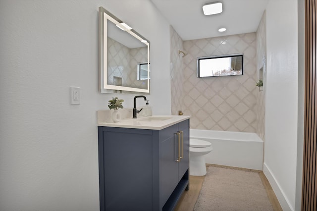 full bath featuring toilet, wood finished floors, vanity, baseboards, and  shower combination