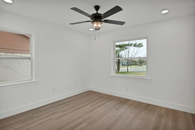 unfurnished room featuring baseboards and wood finished floors