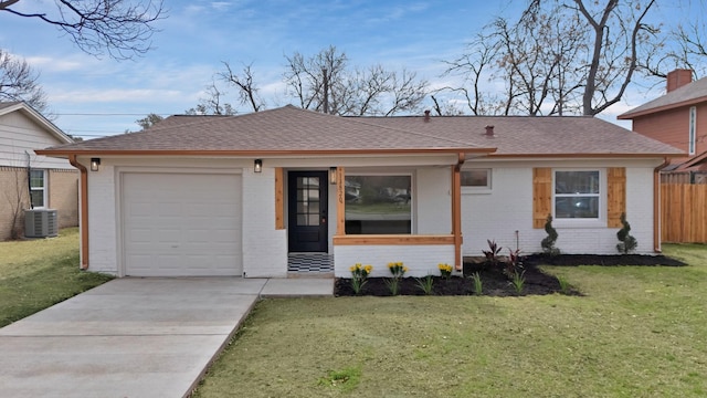 ranch-style house featuring a shingled roof, brick siding, a front lawn, and central AC unit