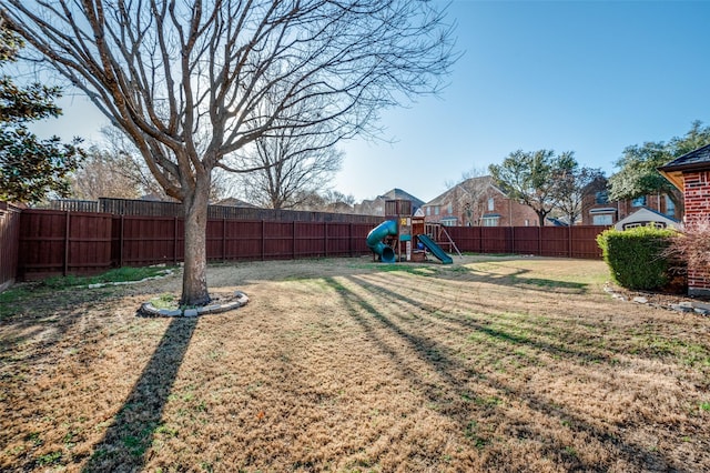 view of yard featuring a playground and a fenced backyard