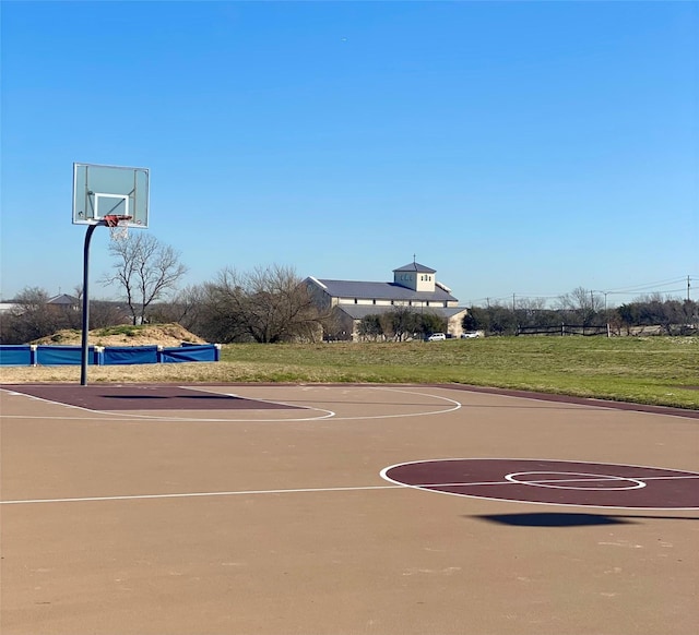 view of basketball court featuring community basketball court and a lawn