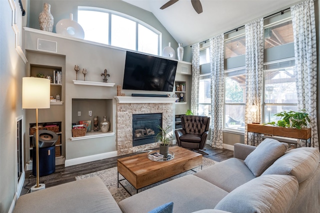 living area with plenty of natural light, a fireplace, and wood finished floors