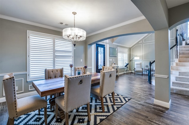 dining space with stairway, arched walkways, visible vents, and a decorative wall