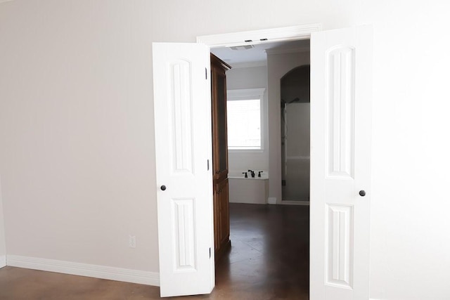 hall with baseboards and wood finished floors