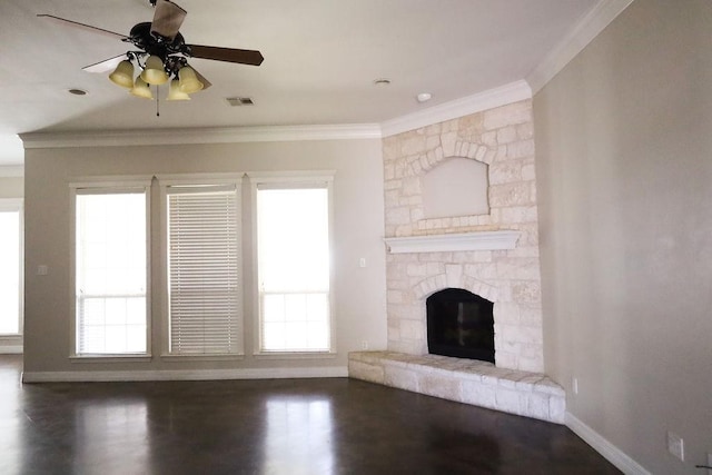 unfurnished living room with a stone fireplace, wood finished floors, visible vents, baseboards, and ornamental molding