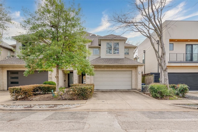 view of front of property with a garage, a shingled roof, and concrete driveway