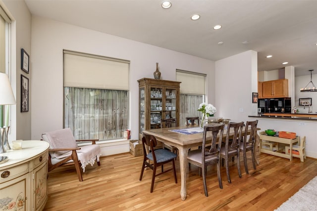 dining room with light wood-type flooring and recessed lighting