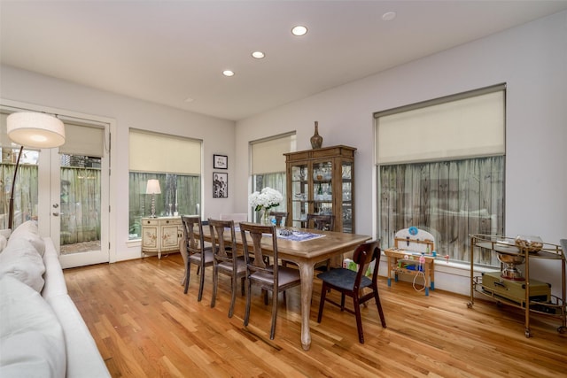 dining area with recessed lighting, french doors, and light wood-style flooring