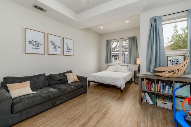 bedroom with visible vents, wood finished floors, and recessed lighting