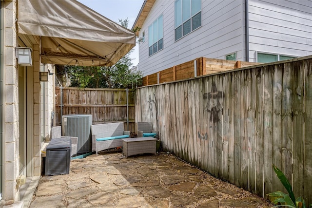 view of patio / terrace featuring a fenced backyard and central AC