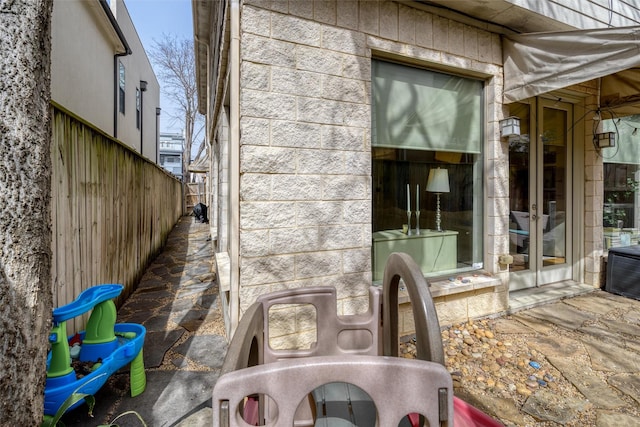 view of patio featuring fence and french doors