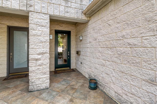 view of exterior entry with concrete block siding