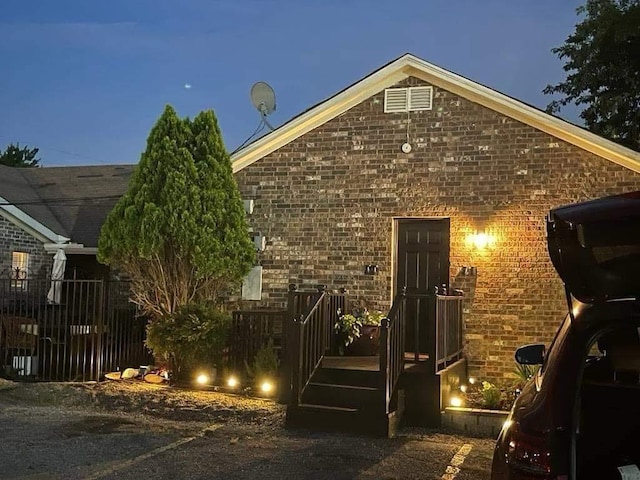 view of side of home with brick siding