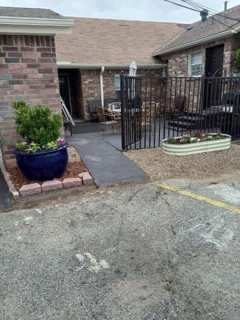 view of gate featuring a patio area