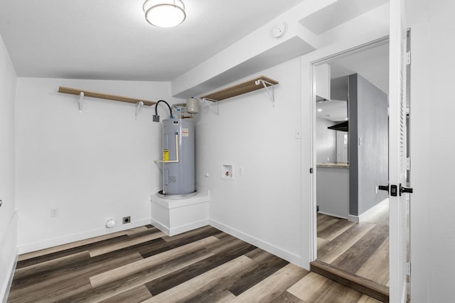 laundry area with hookup for a washing machine, electric water heater, hookup for an electric dryer, wood finished floors, and laundry area