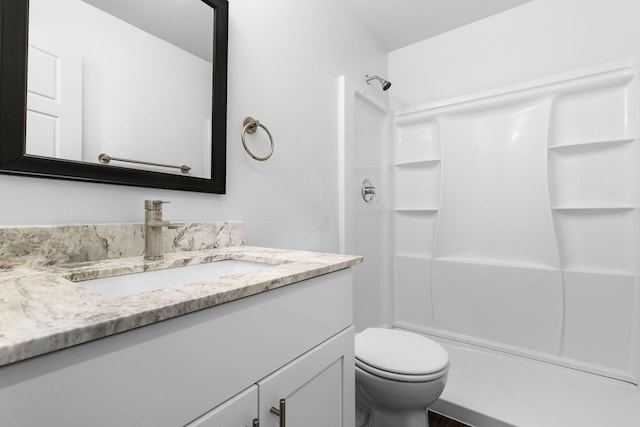 full bathroom with toilet, a shower, and vanity