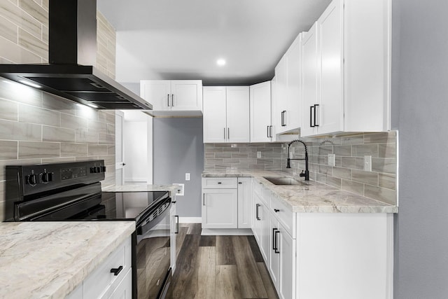 kitchen with wall chimney exhaust hood, dark wood-style flooring, black range with electric stovetop, light stone countertops, and a sink