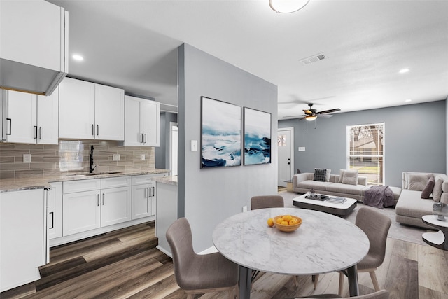 dining area with dark wood-style floors, recessed lighting, visible vents, and ceiling fan