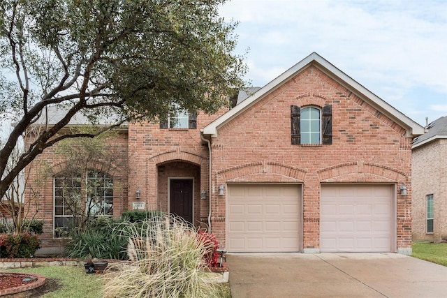 view of front of house with a garage, concrete driveway, and brick siding