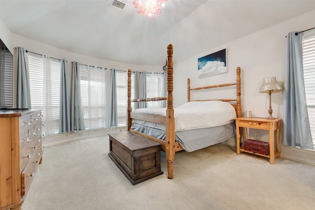 bedroom featuring lofted ceiling, multiple windows, carpet flooring, and visible vents