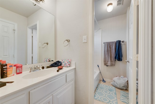 bathroom with bathtub / shower combination, visible vents, and vanity