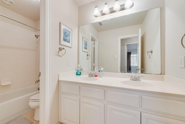 full bathroom featuring visible vents, a sink, toilet, and double vanity