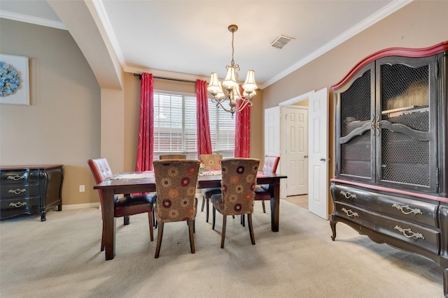 carpeted dining room featuring a chandelier, visible vents, crown molding, and baseboards