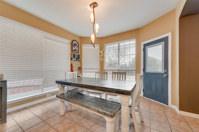 dining space with light tile patterned floors and baseboards