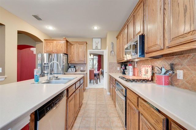 kitchen with light tile patterned floors, a sink, visible vents, light countertops, and appliances with stainless steel finishes