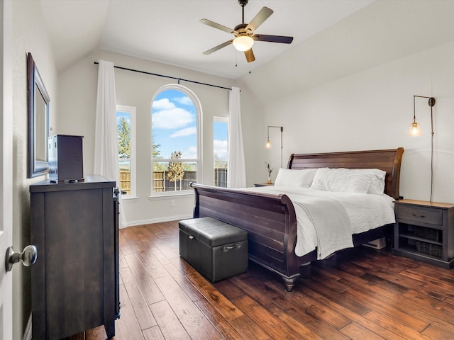 bedroom with ceiling fan, baseboards, lofted ceiling, and wood finished floors