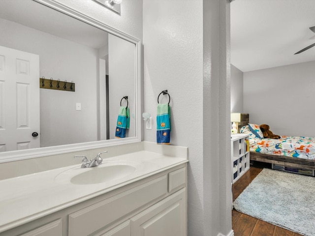 bathroom with vanity, ceiling fan, and wood finished floors