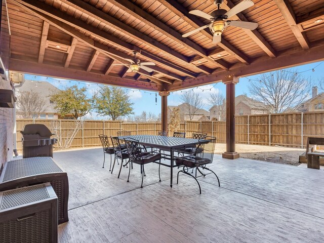 view of patio with a fenced backyard, area for grilling, outdoor dining space, and a ceiling fan