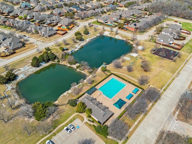 birds eye view of property featuring a water view and a residential view