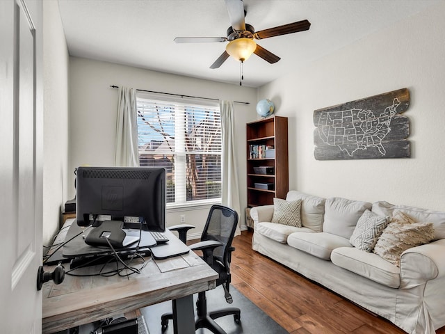 office area featuring baseboards, ceiling fan, and wood finished floors