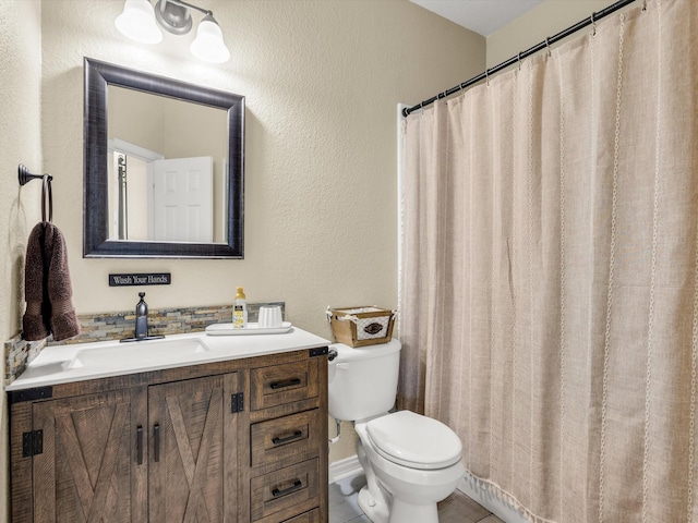 bathroom featuring toilet and vanity