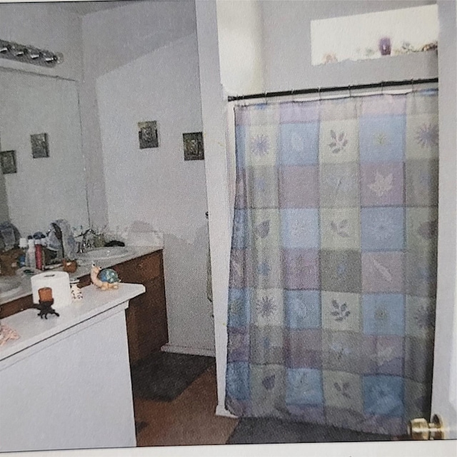 full bath with vanity and a shower with curtain