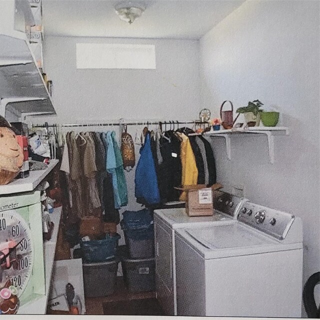 washroom with washing machine and dryer and laundry area