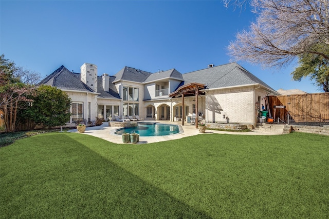 5340 Jessica Ln, Frisco, TX 75034 - rear view of property featuring a balcony, a fenced backyard, a patio area, brick siding, and a pool with connected hot tub