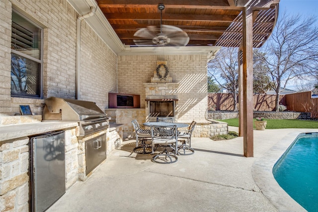 5340 Jessica Ln, Frisco, TX 75034 - fenced backyard featuring area for grilling, exterior fireplace, a patio, and outdoor dining space
