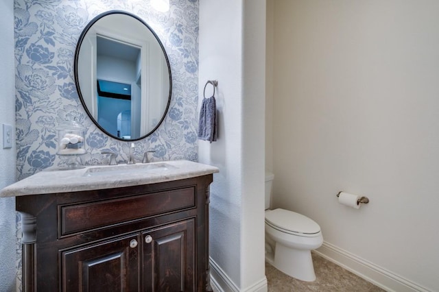 bathroom featuring wallpapered walls, baseboards, toilet, tile patterned floors, and vanity