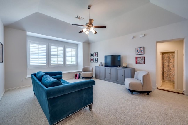 living room with baseboards, visible vents, a ceiling fan, lofted ceiling, and carpet flooring