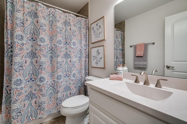 bathroom featuring vanity, toilet, and a shower with curtain