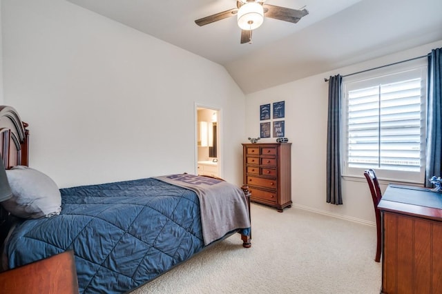 bedroom with light carpet, vaulted ceiling, ceiling fan, ensuite bath, and baseboards