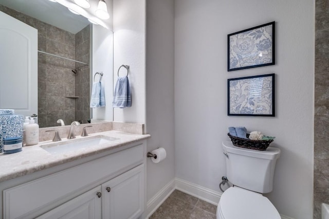 full bathroom featuring toilet, a tile shower, vanity, baseboards, and tile patterned floors