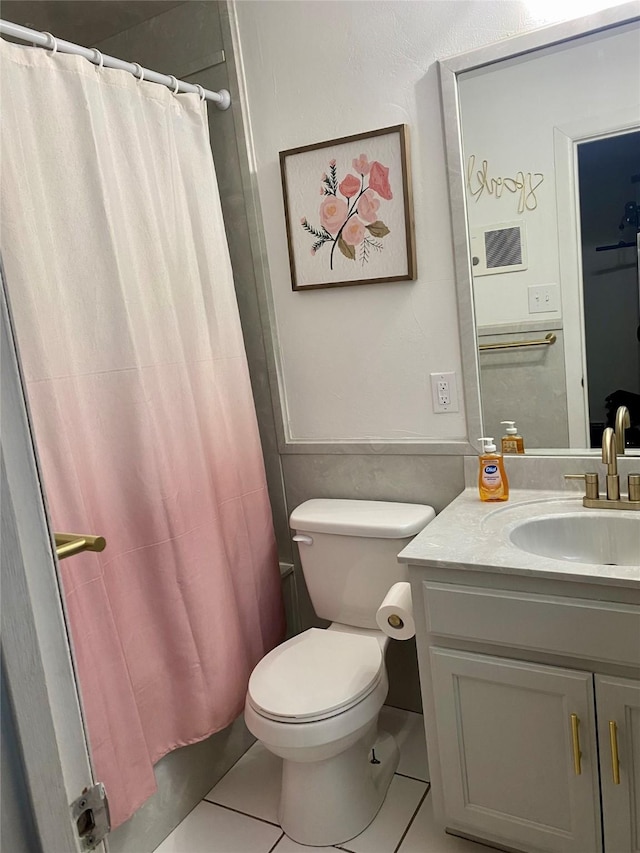 full bath with vanity, toilet, and tile patterned floors