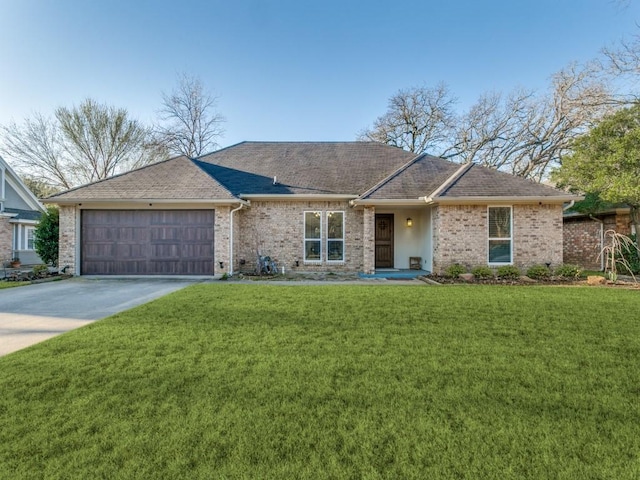 ranch-style home featuring brick siding, an attached garage, concrete driveway, and a front lawn