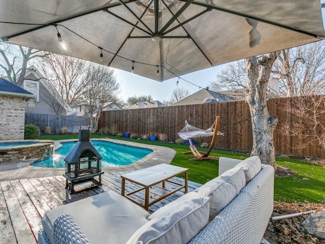 view of pool with outdoor lounge area, a fenced backyard, and a pool with connected hot tub