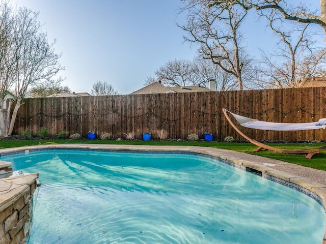 view of swimming pool with a fenced in pool and a fenced backyard